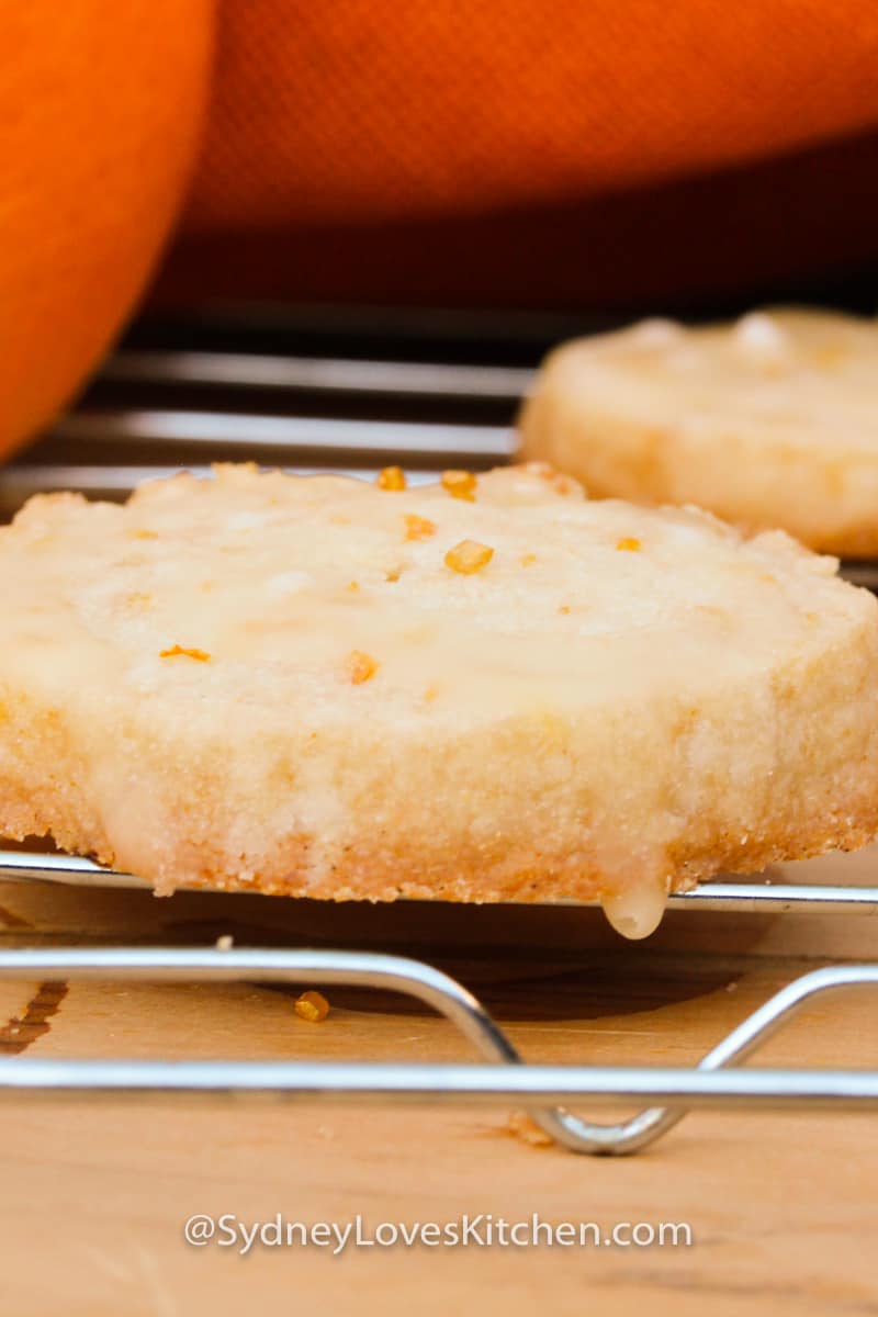 close up of orange cookie with glaze