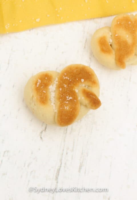 two pretzels cooked and placed on a white board