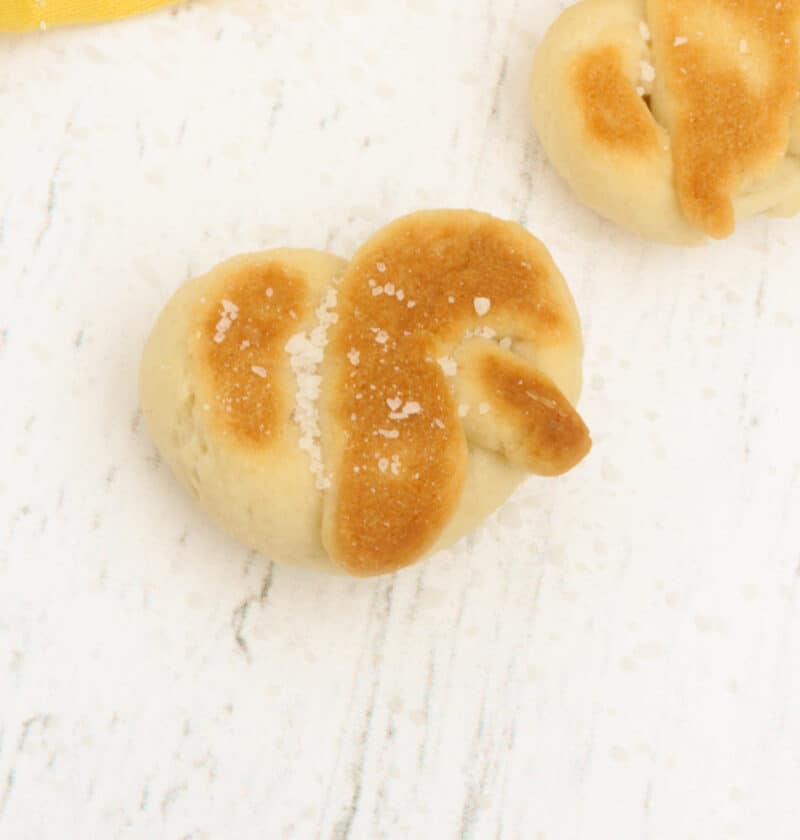 two pretzels cooked and placed on a white board