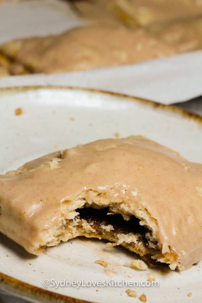 Close up of the inside of a glazed pop tart after a bite is taken out of it.