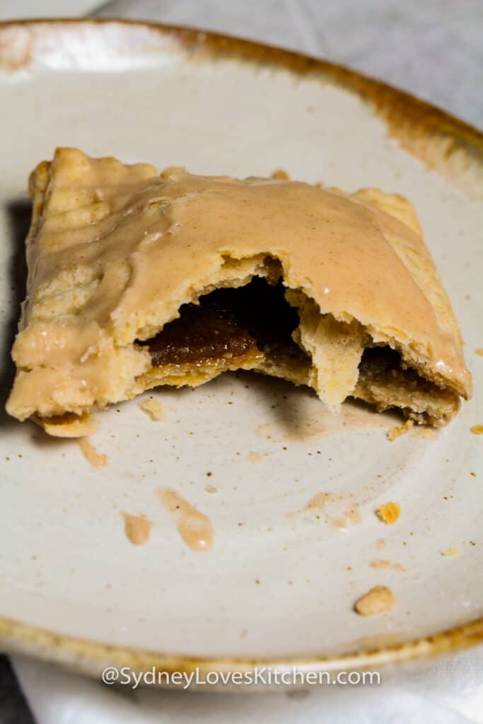 Bite of homemade pop tarts taken out of it and on a plate